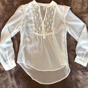 Sheer white blouse with lace.